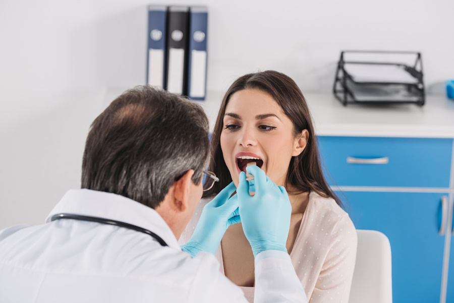 doctor checking throat for singing issue
