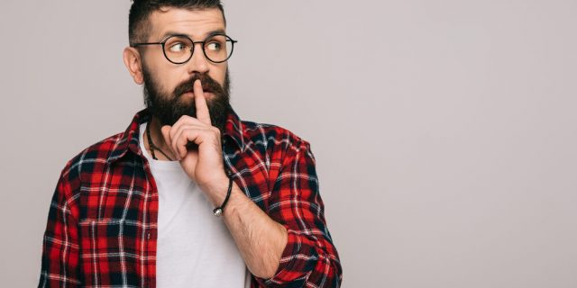 man showing silence symbol