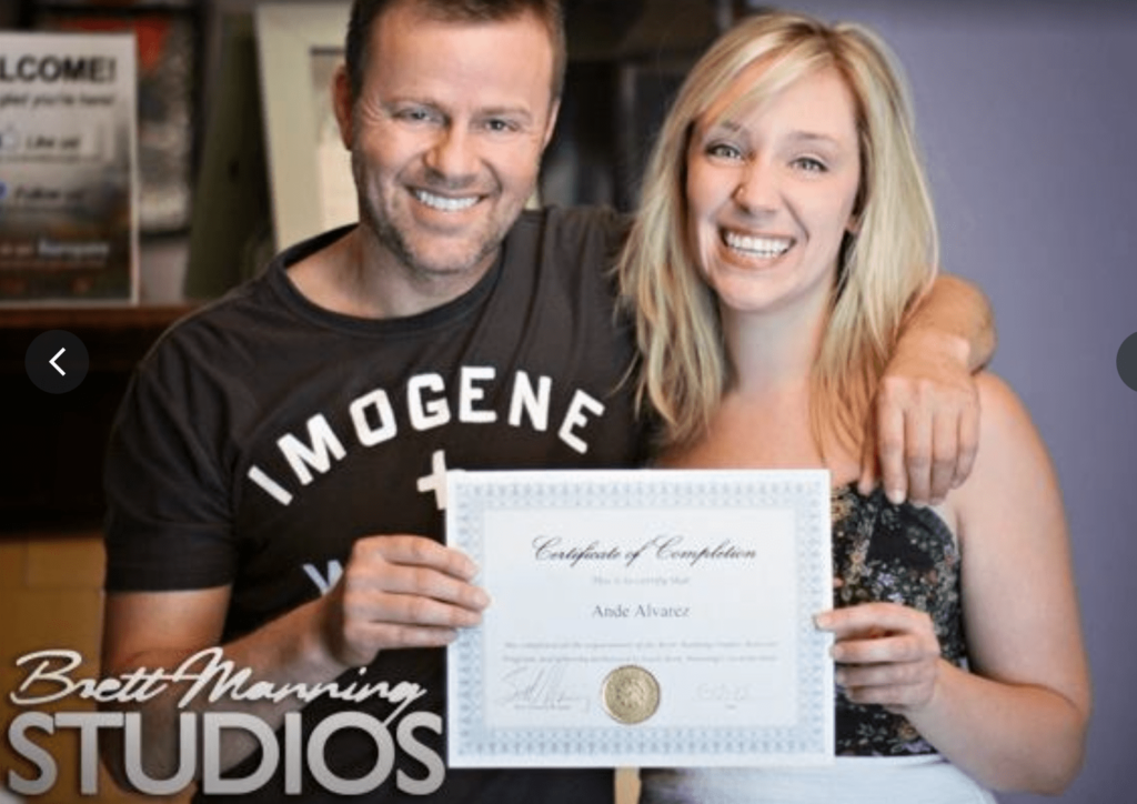 teacher Brett Manning with a student, presenting a certificate of completion