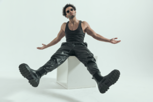 rock star sitting on a white cube